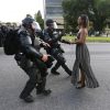 A demonstrator protesting the shooting death of Alton Sterling is detained by law enforcement near the headquarters of the Baton Rouge Police Department in Baton Rouge, Louisiana, U.S. July 9, 2016. REUTERS/Jonathan Bachman TPX IMAGES OF THE DAY - RTSH3XR